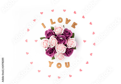 Valentine's day concept. Declaration of love, frame made of paper hearts. In the center flowers in a box. Engagement ring in rose. Flat lay, top view, white background, isolated, copy space