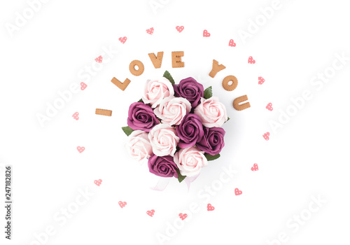 Valentine's day concept. Declaration of love, frame made of paper hearts. In the center flowers in a box. Flat lay, top view, white background, isolated, copy space