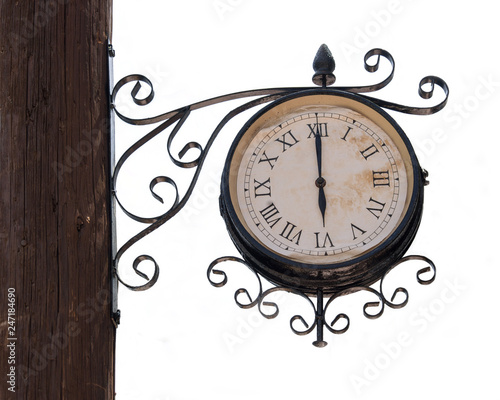 Vintage street clock on a wooden pole isolated on white background