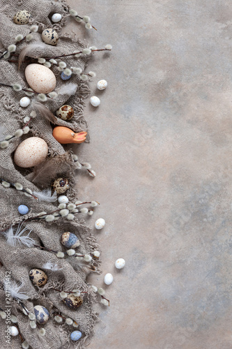 Easter decoration – natural eggs and pussy willow. Top view, close up, flat lay on light concrete background