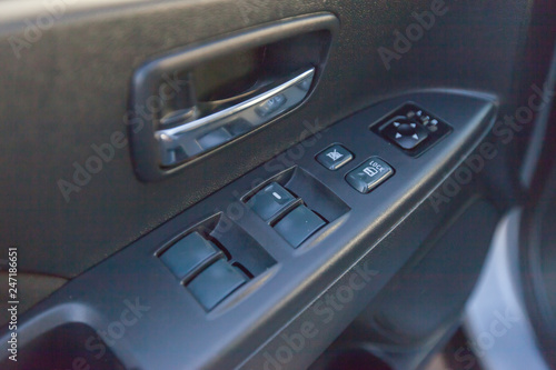 buttons of window regulators in an automobile door © n_vinokurov