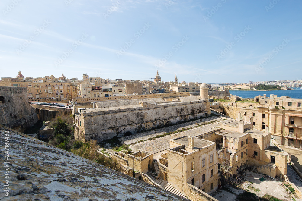 Dilapidated part of Fort St Elmo, Valletta with Valletta in the background on a sunny day