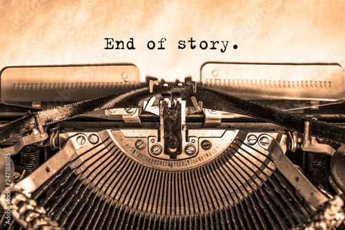  end of story printed on a vintage typewriter on a sheet of paper. writer, journalist.