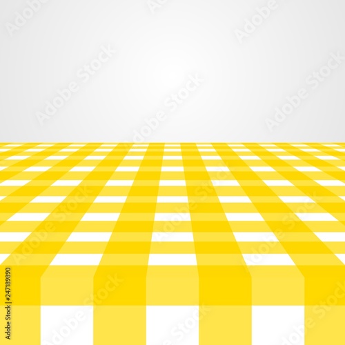 Checked tablecloth of yellow and gray geometric shapes on the table. Background of colored squares and rectangles on a white background. Yellow fabric with gray backdrop 
