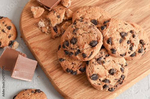 Tasty homemade chocolate chip cookies on gray background, top view