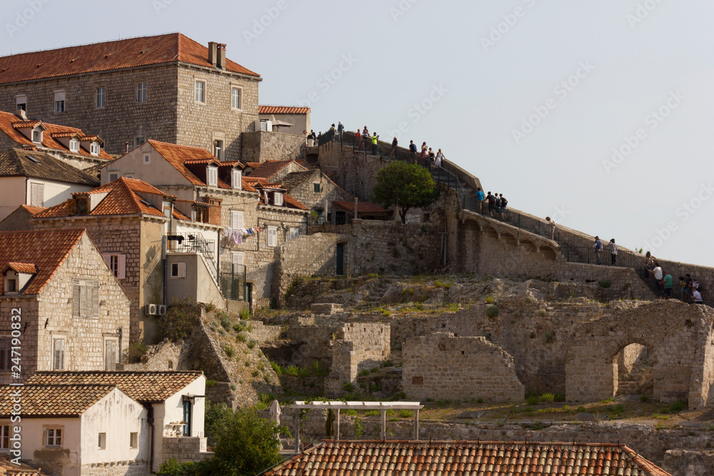 DUBROVNIK, CROATIA - AUGUST 22 2017: Dubrovnik ancient town walls, surrounded by houses