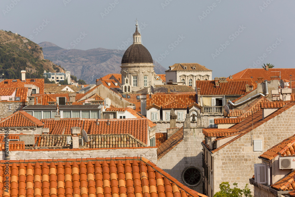 DUBROVNIK, CROATIA - AUGUST 22 2017: View from the top of town walls of Dubrovnik roofs, with Cathedral dome