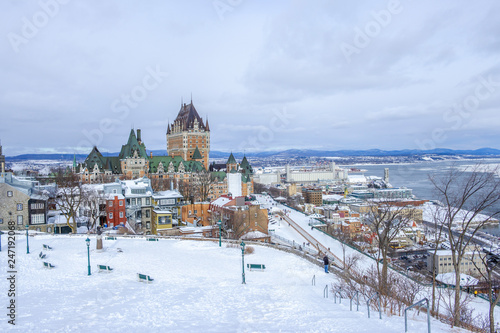 Scenic view of old castle on hill on bank of Saint Lawrence river in capital of Quebec province in Canada. Depressive beautiful winter look of historical building in Quebec city