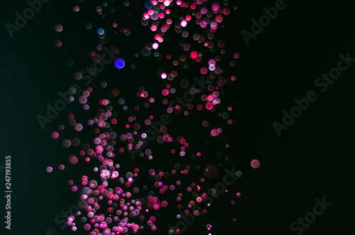 abstract bright colorful violet and red bokeh glitter sparkle blurred background. like molecule spread and absorb.