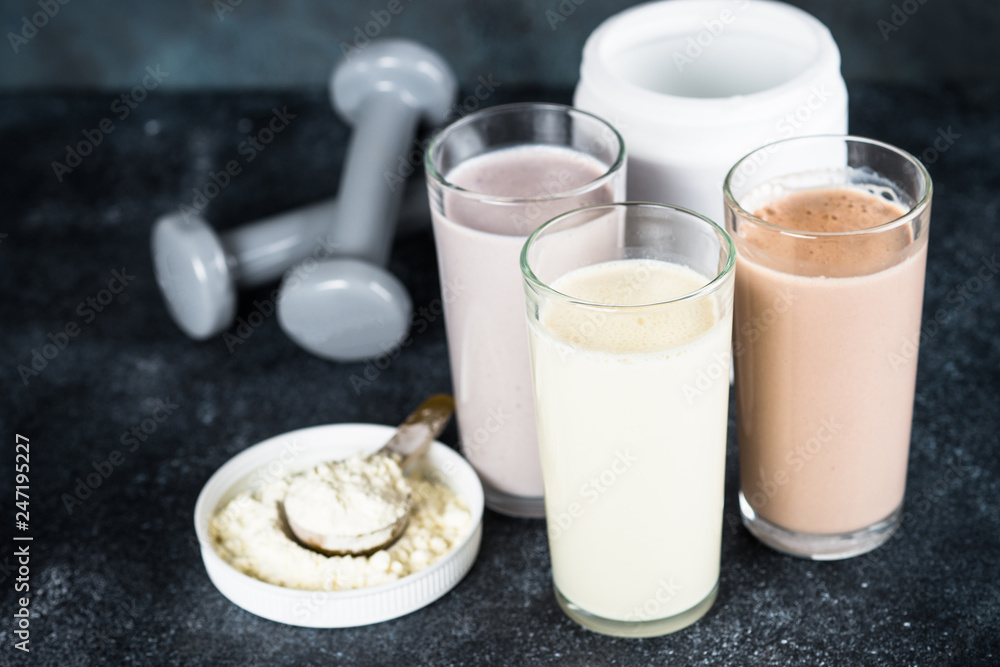 Protein cocktails and dumbbells, sport and fitness concept. Protein cocktails and dumbbells, sport and fitness concept.