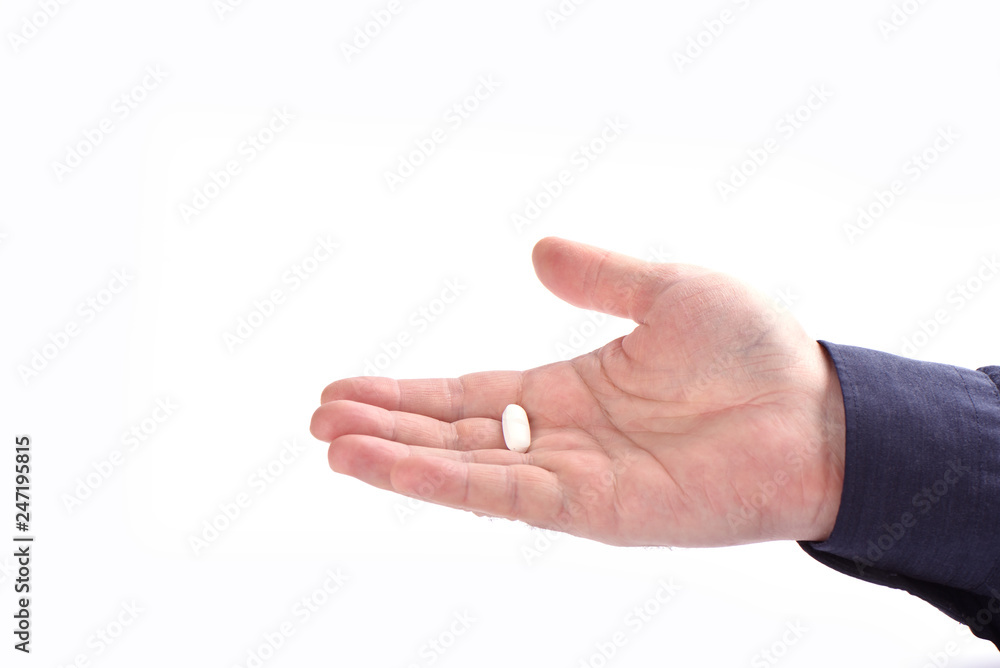 Medicine tablet on male palm isolated on white background Medicine tablet on male palm isolated on white background