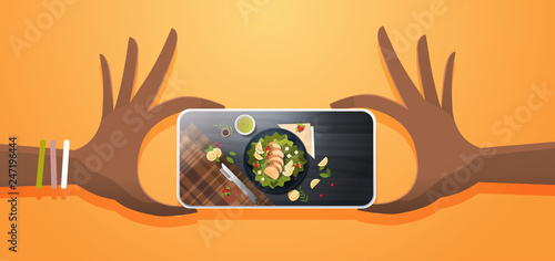 food blogger taking mobile photo of fresh vegetable salad with chicken and sauce top angle view smartphone screen social network activity concept horizontal