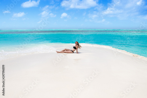 Blonde Girl in black bikini on dream beach at the turquoise ocean © nakedking