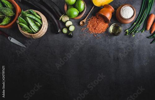 Various fresh vegetables on a black table with space for a message