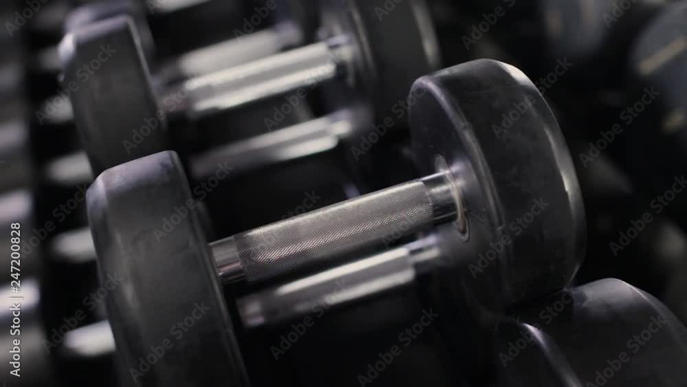 Set, a rack of dumbbells of different sizen for training, close-up. Set, a rack of dumbbells of different sizen for training, close-up.
