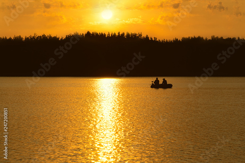 Fishermen catch fish on the lake at sunset. © Chetgal 