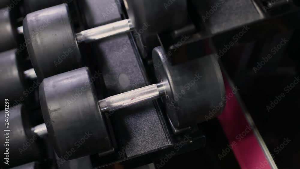 Set, a rack of dumbbells of different sizen for training, close-up. Set, a rack of dumbbells of different sizen for training, close-up.