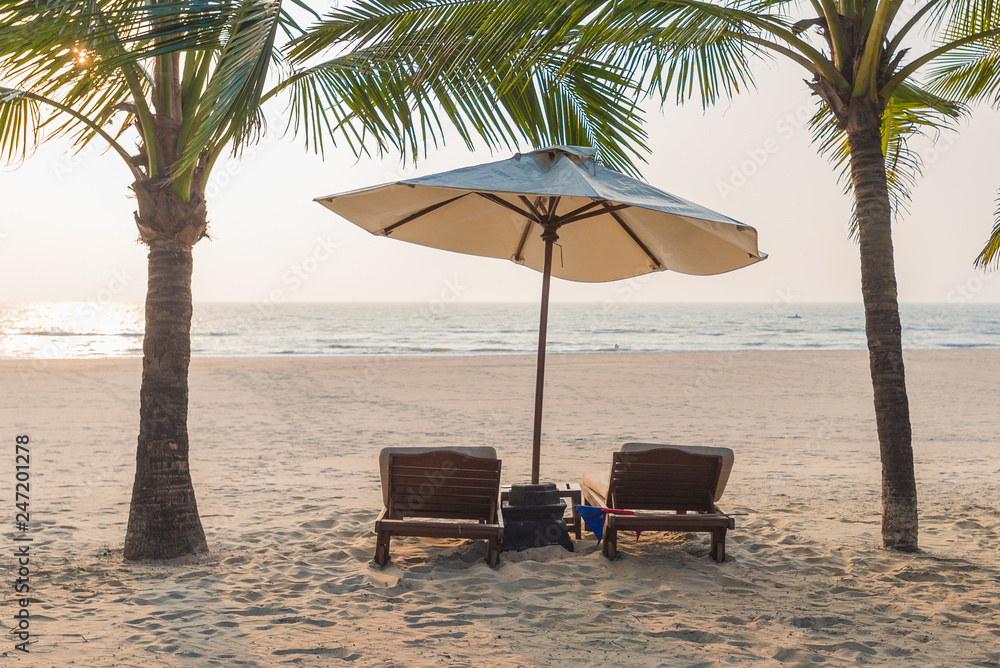 Vacation holidays background of two beach lounge chairs under tent on beach.  Goa, India Stock Photo | Adobe Stock