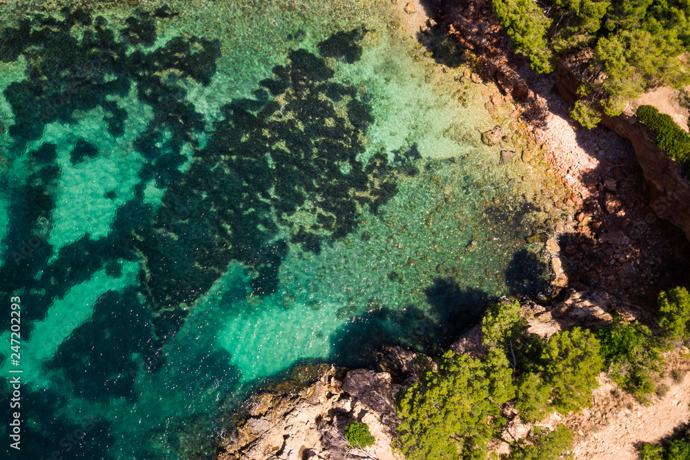 Aerial view of clear blue green water in bay Cala Marmassen, Andratx. Mallorca Spain