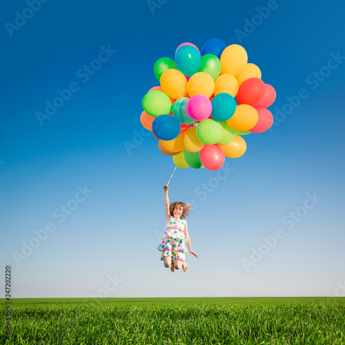 Happy child playing outdoors in spring field