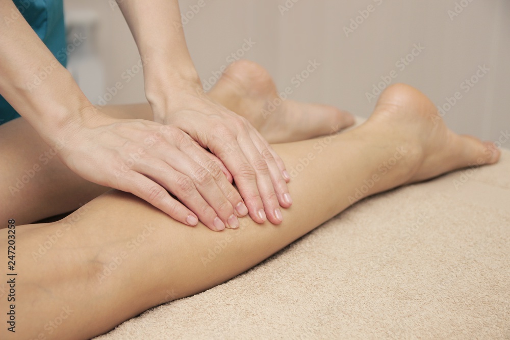 Masseur doing therapeutic foot massage for a woman Masseur doing therapeutic foot massage for a woman