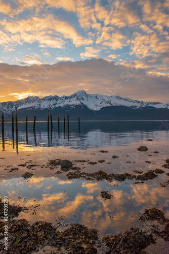 Alaskan sunrise reflection with snow covered mountains photo