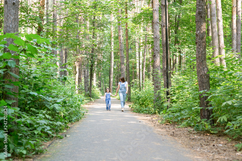 Family, park, people concept - Mom and daughter spend time together on a walk on nature