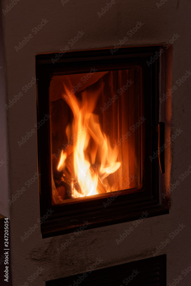 Flames in a wood burning stove in a house Flames in a wood burning stove in a house