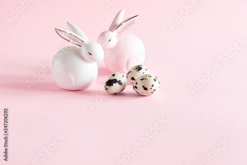 Easter rabbit on light pastel pink background, quail eggs. Easter holiday concept. copy space, close-up