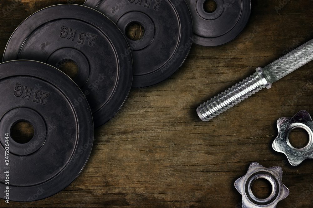 Dumbbells and weights are lying on the floor in the gym. Barbell set and gym equipment. Metal loads in the fitness club Dumbbells and weights are lying on the floor in the gym. Barbell set and gym equipment. Metal loads in the fitness club