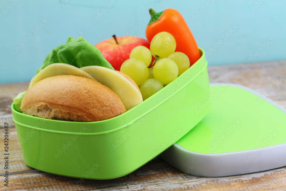 School lunch containing cheese roll, crunchy yellow pepper and fresh fruit: apple and grapes
School lunch containing cheese roll, crunchy yellow pepper and fresh fruit: apple and grapes