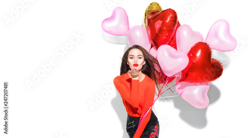Valentine's Day. Beauty girl with colorful air balloons having fun, isolated on white background