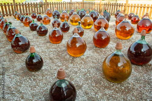 Фотография Making of natural sweet dessert muscat liqueur white wine outside in big round g