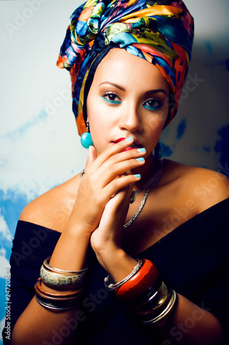 beauty bright african woman with creative make up, shawl on head like cubian closeup smiling photo