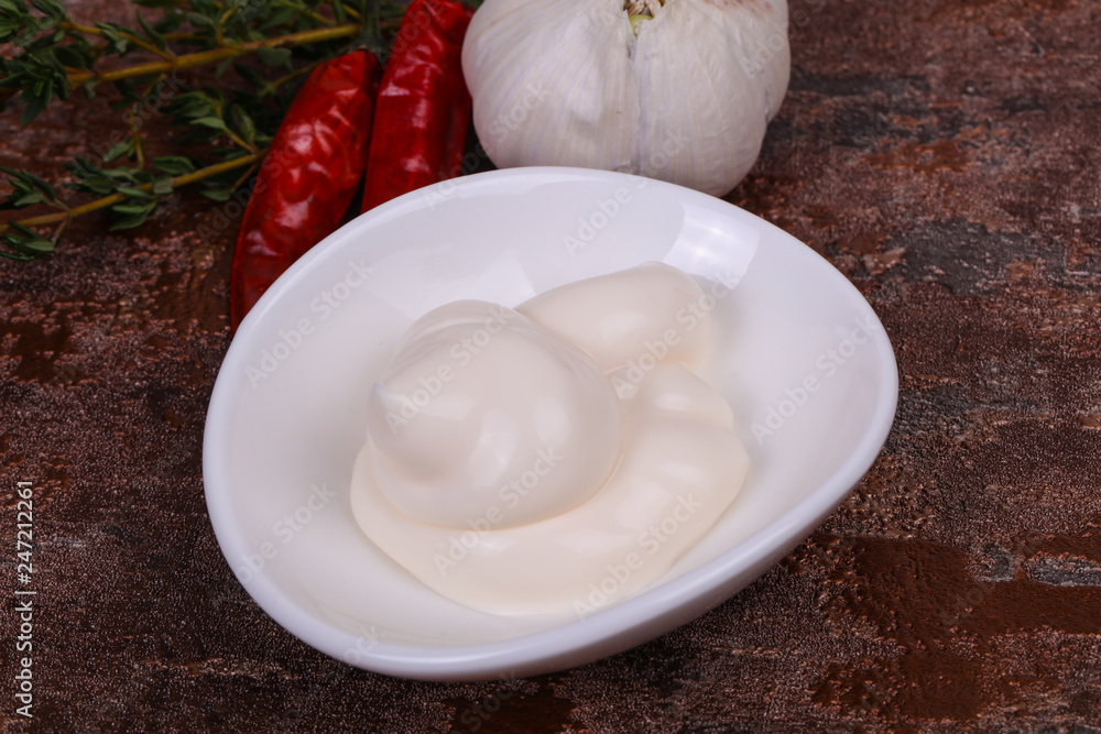 Mayonnaise sauce in the white bowl served thyme and garlic Mayonnaise sauce in the white bowl served thyme and garlic