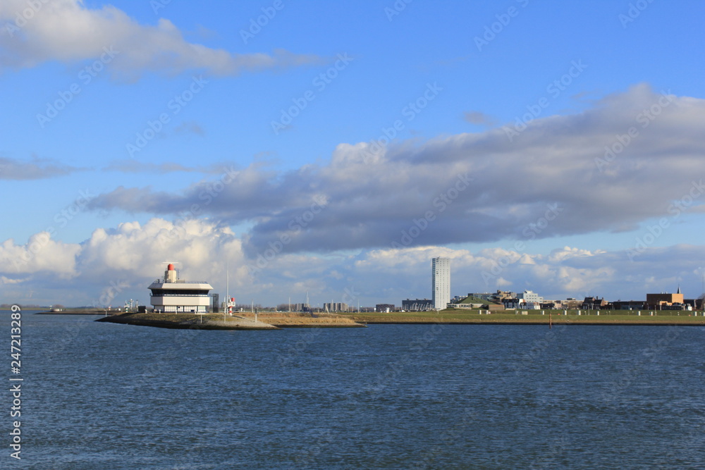 the skyline of terneuzen, holland in winter with a blue sea and sky