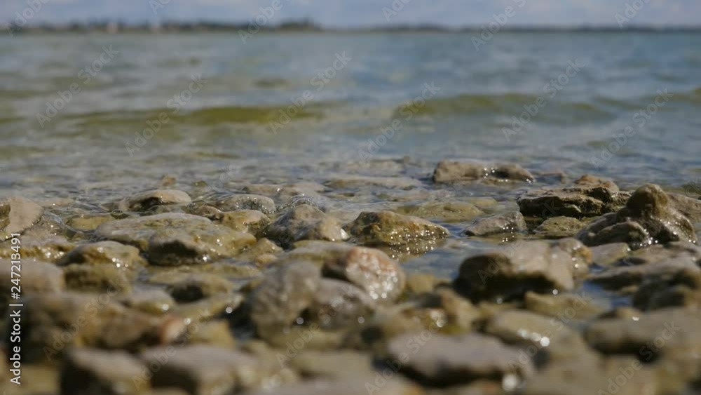 The Dnipro and its bank covered with shingles, pebbles and stones n summer The Dnipro and its bank covered with shingles, pebbles and stones n summer