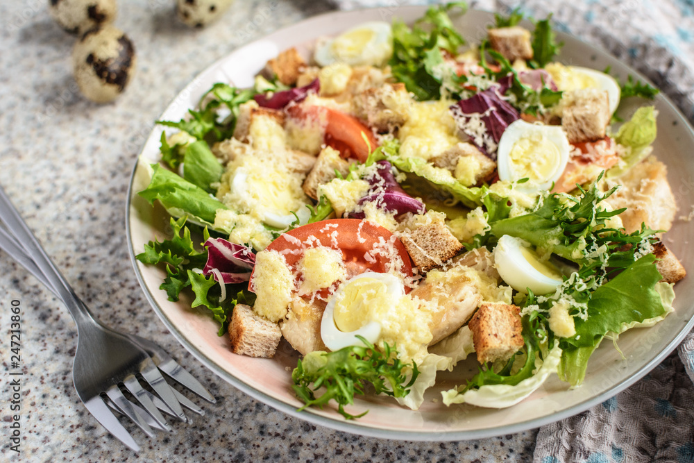 Fresh caesar salad with chicken breast, lettuce and tomatoes. Delicious spring salad Fresh caesar salad with chicken breast, lettuce and tomatoes. Delicious spring salad