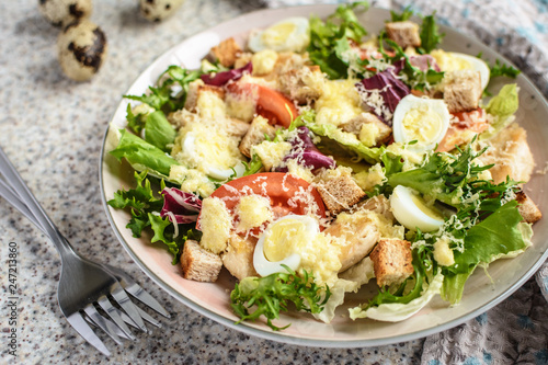 Fresh caesar salad with chicken breast, lettuce and tomatoes. Delicious spring salad