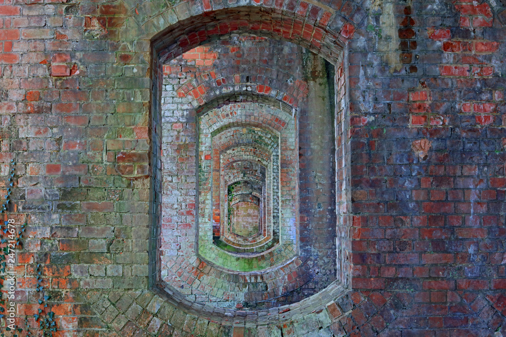 View Through Colourful Arched Stone Work