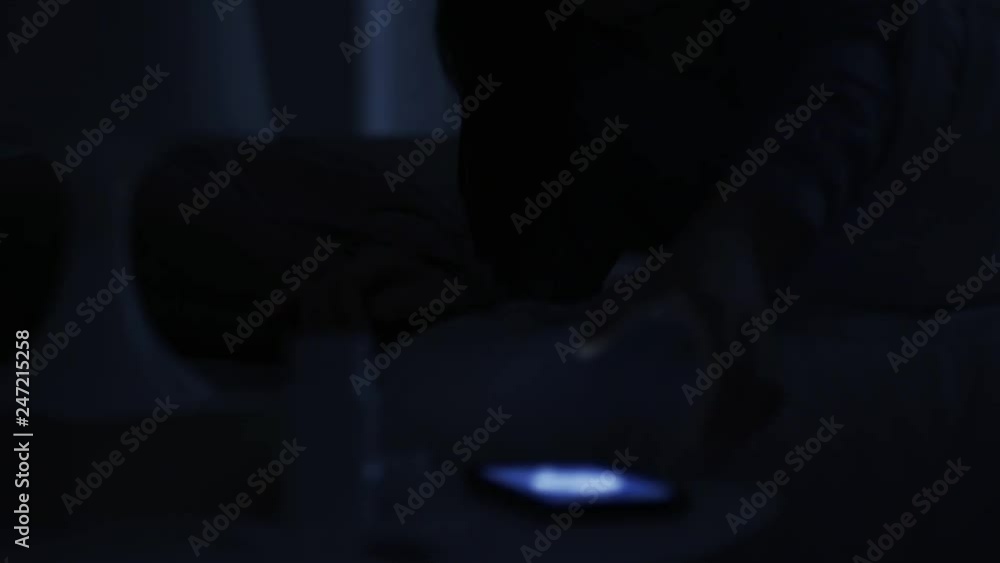 Woman receiving a phone call late at night Woman receiving a phone call late at night