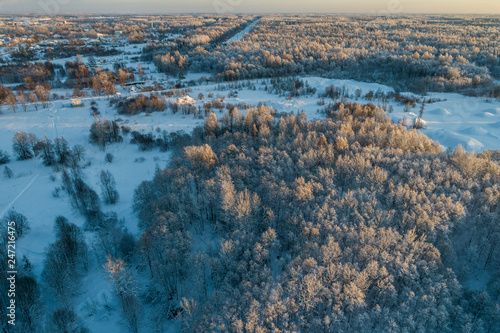 Aerial view of a beautiful sunset in the winter forest. 