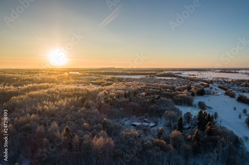 Aerial view of a beautiful sunset in the winter forest. 