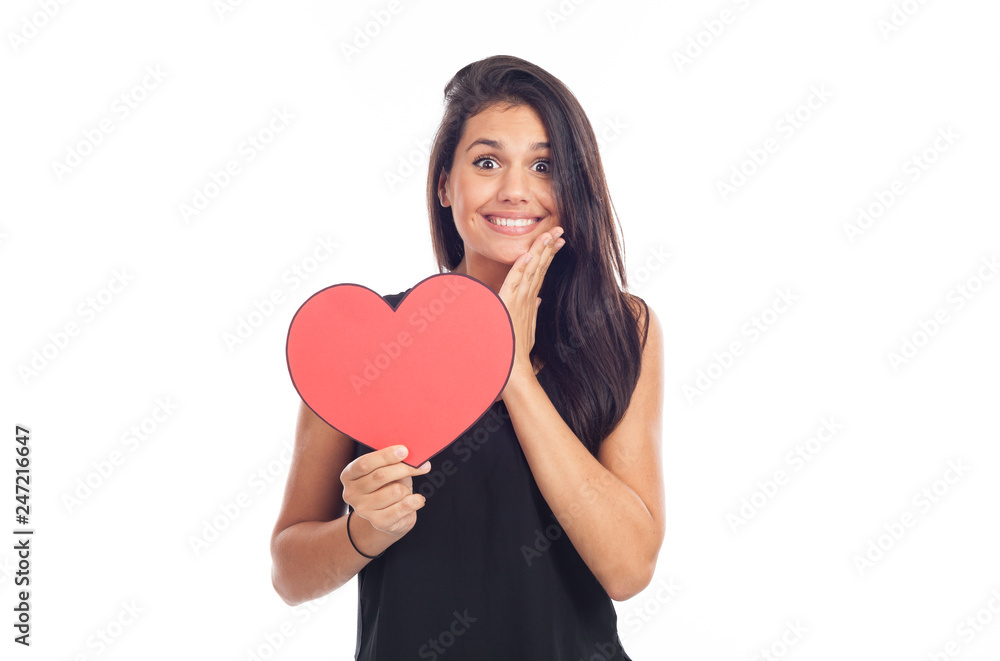 beautiful happy brunette woman holding and showing a big red heart beautiful happy brunette woman holding and showing a big red heart