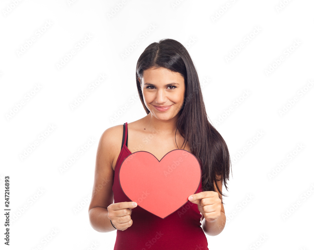 beautiful happy brunette woman holding and showing a big red heart beautiful happy brunette woman holding and showing a big red heart