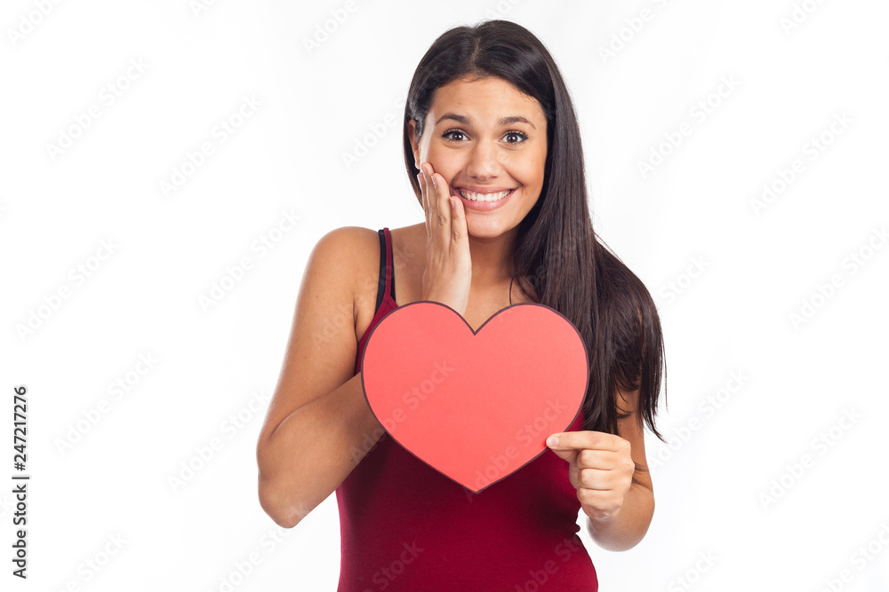 beautiful happy brunette woman holding and showing a big red heart beautiful happy brunette woman holding and showing a big red heart