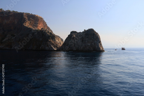 Rocky sea coast with the boat.