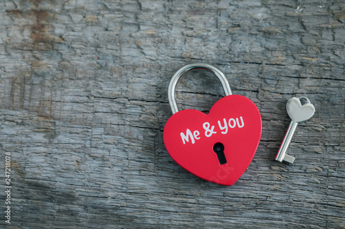 Red heart-shaped padlock with key on wooden background, St Valentine's Day or Marriage postcard