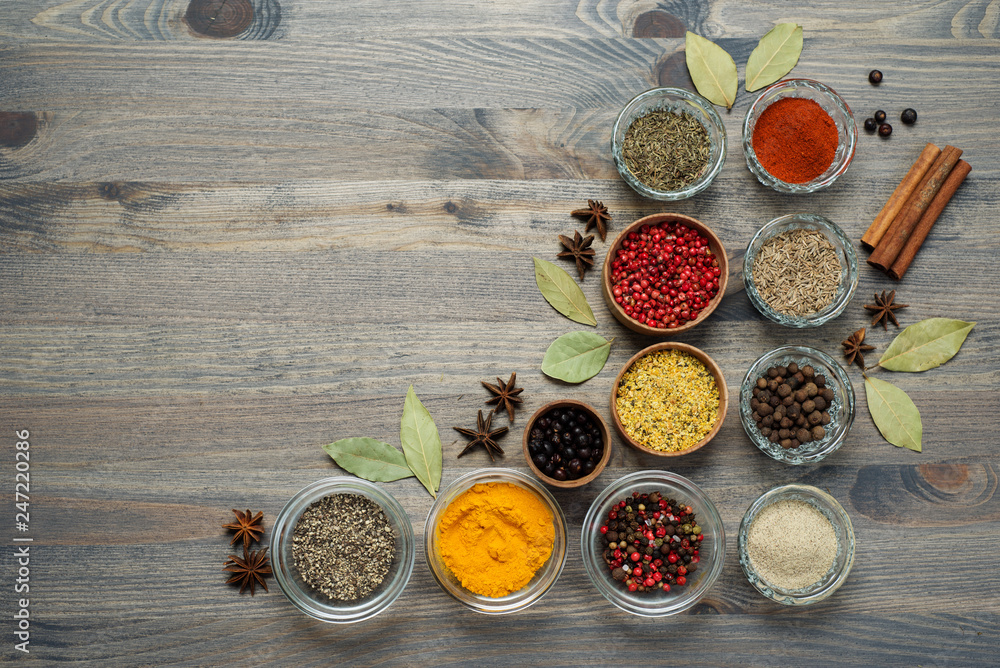 Spices and seasonings on the gray wooden background. Place for text. Spices and seasonings on the gray wooden background. Place for text.