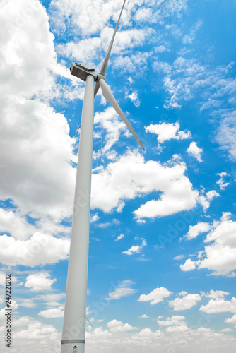 The wind generator is in bright cloudy sky. Eco energy concept.
